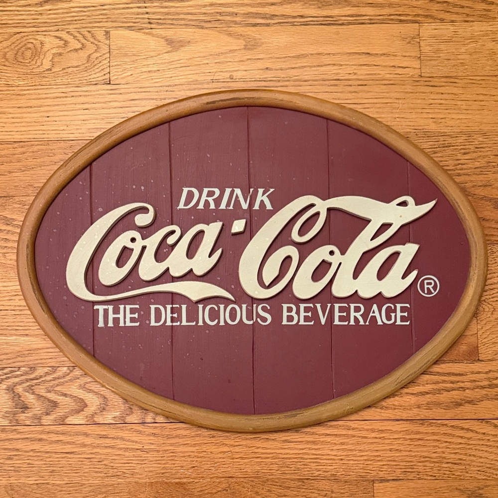 Coca-Cola Oval Sign in Maroon and Cream Letters